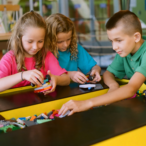 Kids playing at the Lego table in Invention Dimension