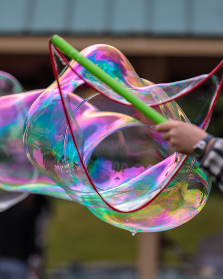 Woman holding large bubble wand
